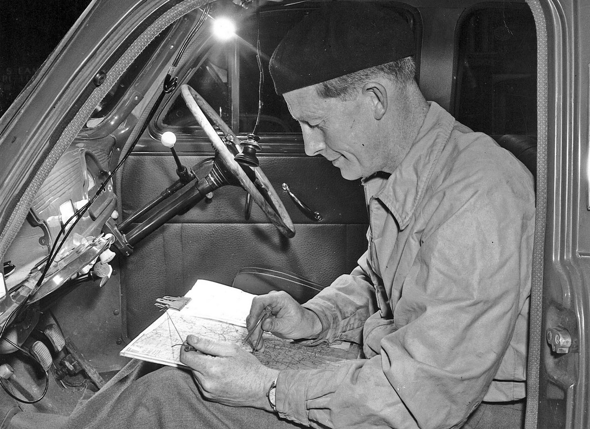 BP Rally Director, Donald Thomson sitting in a car with maps open.